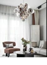 Smoky gray chandelier with glass bubbles hanging over a modern dining table