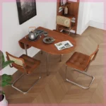 Nordic minimalist folding dining table with stainless steel telescopic extension in a modern living room setting
