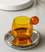 Nordic coffee cup set with saucer and spoon on a wooden table