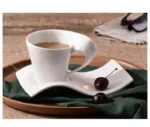 White porcelain espresso cup with wavy design on saucer, modern home decor