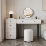 Modern minimalist makeup vanity table with mirror and stool in a bedroom setting