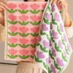 Quick dry beach towel for kids in vibrant tulip print on sandy beach