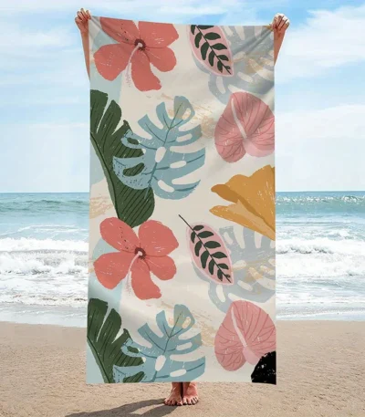 quick dry beach towel with tropical flowers and leaves pattern on sand