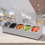 Stainless steel spice rack with 5 pans and lids on kitchen countertop