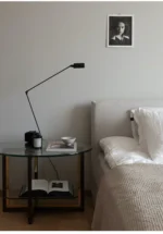 Floor lamp with a minimalist look, standing alone in a bright hallway.