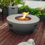 50,000 BTU fire pit table with grey steel finish and propane tank holder on a patio