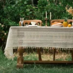 Retro polka dot tablecloth with fringe on a wooden table