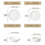 Elegant ceramic plates set with dinner plates, dessert plates, cereal bowls, and soup bowls arranged on a wooden table