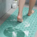 Oblong non-slip bath mat with suction cups on shower floor