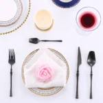 Matte black gold flatware set arranged on a table, showcasing elegant cutlery