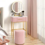 Marble top dressing table with lighted mirror and stool in a bedroom setting