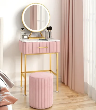 Marble top dressing table with lighted mirror and stool in a bedroom setting