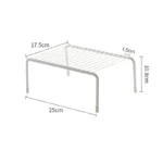 Adjustable dish drying rack with multiple tiers holding plates, bowls, and spice jars on a kitchen counter