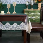 Elegant waterproof table protector with lace embroidery on a rectangular dining table