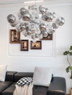 Smoky gray chandelier with glass bubbles hanging over a modern dining table