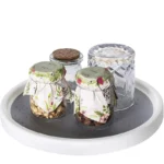 Goldoma rotating spice rack with multiple spice jars on a kitchen counter