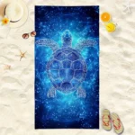 Blue star turtle quick dry beach towel on sand with ocean background