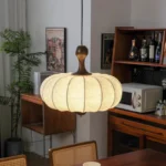 Walnut wood chandelier with fabric shades in a cozy living room