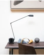 Close-up of the lamp's metal stem, showing the smooth black paint and slight sheen.