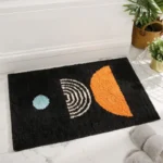 Modern abstract art non slip bathroom rug with vibrant colors and textured surface on a bathroom floor
