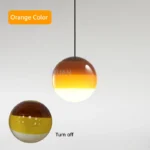 Close-up of a pink glass pendant lamp, emphasizing its smooth surface and color vibrancy.