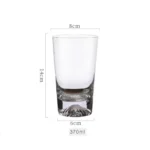 Transparent snow mountain whiskey glasses with Mount Fuji shape on a wooden table