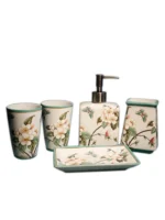 Ceramic mouthwash cup with floral design, on bathroom sink with toothbrush holder.