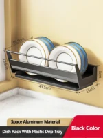 Stainless steel wall mounted dish rack holding plates and bowls in a modern kitchen
