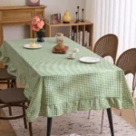 French country tablecloth with retro plaid pattern and lotus leaf edge on a dining table