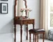 Classic solid wood vanity with mirror and drawer in a cozy bedroom setting