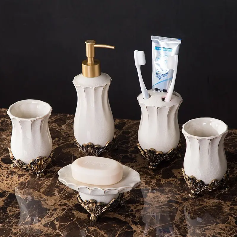 European-style White Porcelain Lotion Bottle Rinsing Cup Toothbrush Holder Bathroom Accessories European-style white porcelain lotion bottle with vintage palace design on a marble countertop.