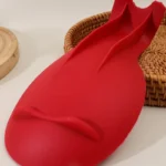 Silicone spoon rest holding a wooden spoon on a kitchen counter