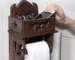 Vintage wood paper towel rack on a bathroom counter, natural grain and brown finish visible.
