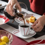 MALACASA Felisa red stripe dinnerware set arranged on a dining table