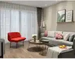 Modern floor lamp with iron frame and glass shade in a cozy living room