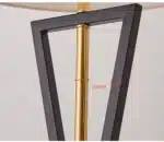 Modern floor lamp with iron frame and fabric shade in a contemporary living room