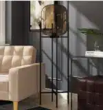 Modern floor lamp with iron frame and glass shade in a cozy living room