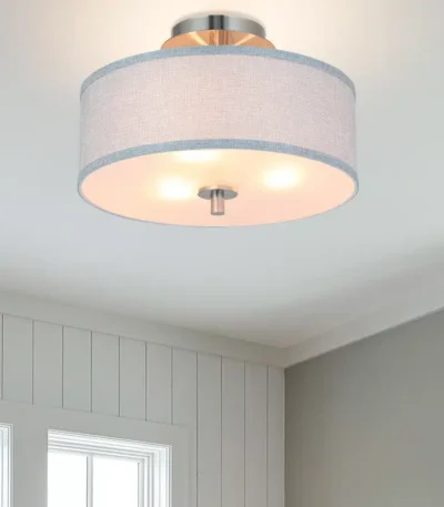 Round fabric pendant ceiling light with black canopy, shown from a side angle in a bright living room setting.