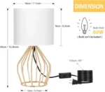 Modern gold table lamp with linen shade on bedside table in bedroom