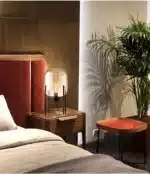 Modern floor lamp with iron frame and glass shade in a cozy living room