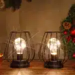 Set of two metal cage table lamps with warm glow on wooden table