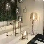 Modern floor lamp with iron frame and glass shade in a cozy living room