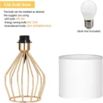 Modern gold table lamp with linen shade on bedside table in bedroom