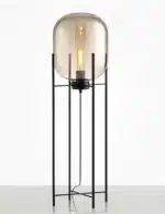 Modern floor lamp with iron frame and glass shade in a cozy living room