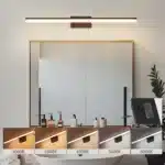 Modern black vanity light with LED bar illuminating a bathroom mirror