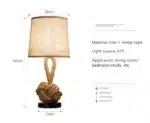 Vintage table lamp with hemp rope and iron base, emitting warm light on a bedside table