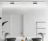 Modern black vanity light with LED bar illuminating a bathroom mirror