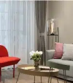 Modern floor lamp with iron frame and glass shade in a cozy living room