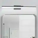 Modern black vanity light with LED bar illuminating a bathroom mirror