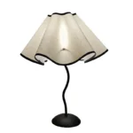 Elegant handmade petal lampshade casting a warm glow in a cozy bedroom